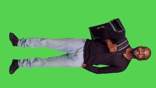 Vertical Video Front View of African American Person Working As Deliveryman on Camera