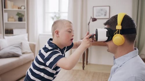 Child Adjusts VR Headset on Adult in Living Room