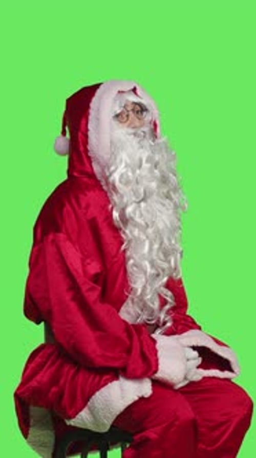Side View of Man Dressed As Santa Claus on Chair Sitting