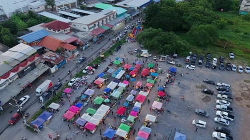 Aerial View of a Large Rural Openair Market Near the Highway Next to the Trees