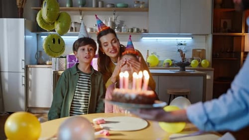 Family Celebrating a Birthday at Home with Cake
