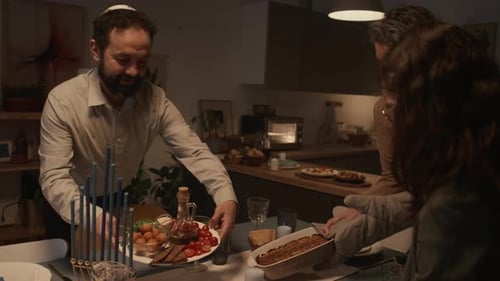 Family Setting Hanukkah Dinner Table