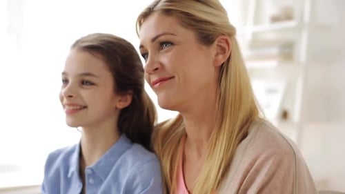 Mother and Daughter Smiling Together Indoors