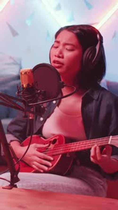 Asian Girl Playing Ukulele and Singing in Mic at Home Recording Studio