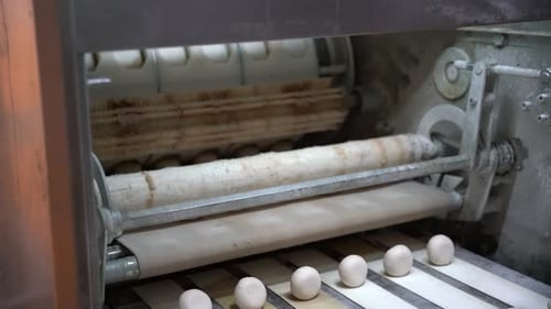 Small Breads are Formed on the Machine at the Bread Factory