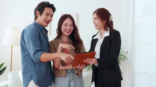 Happy asian couple during visit house from real estate agent after success property purchase home.