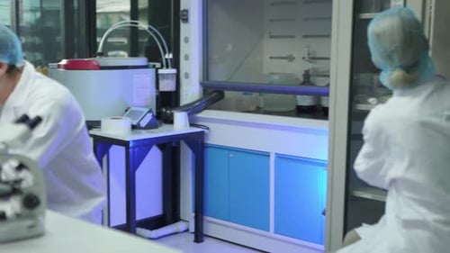Researchers conduct experiments in laboratory with microscopes and samples
