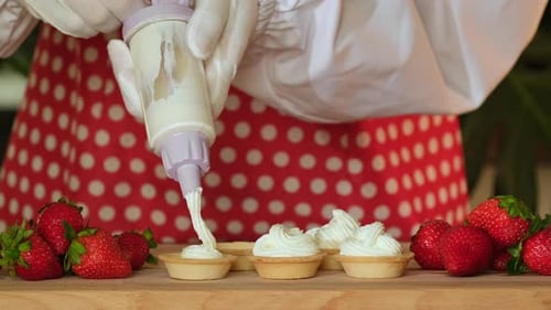 Cooking sweet tartlet with berry. Tasty dessert. Cake with strawberry