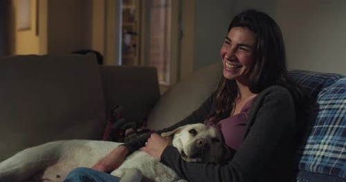 Woman Relaxing on Couch with Loyal Dog