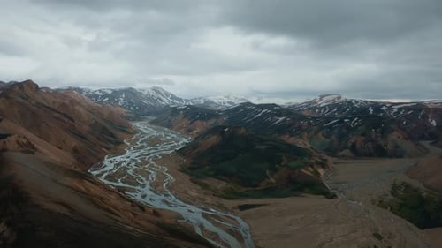 Aerial view of Landmannalaugar mountains with visible river estuary, ice peaks, and clouds. Part 2.