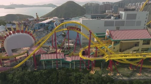 Sideways follow shot of 'Hair-Raiser' rollercoaster in Ocean Park, Hong Kong