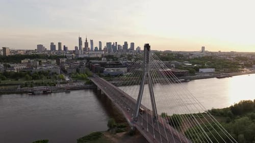 Cars Driving Through Swietokrzyski Bridge Over Vistula River With Warsaw Skyline In The Background A
