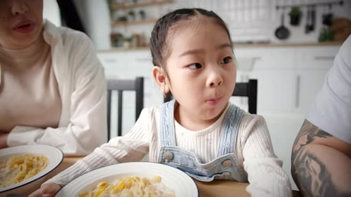 Family Eating Cereal Together at Home