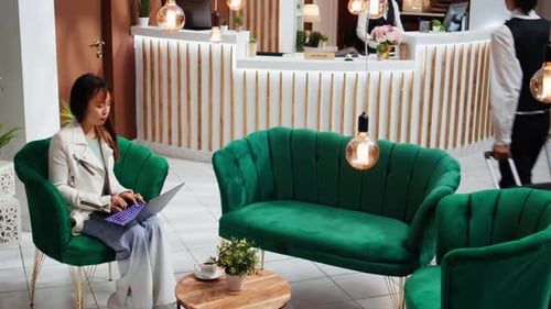 Traveler Solving Tasks on Laptop Upon Her Arrival at Hotel