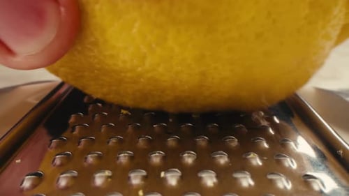 Lemon And Grater Macro Close Up Shot of a Professional Chef Grating Lemon Zest for Lemonade Salad