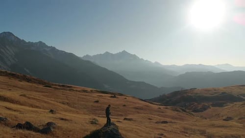 Looking out into the beautiful distant mountain range while flying back over two hikers making their