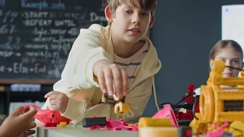 Boy Assembling Robotic Toy during School Science Lesson