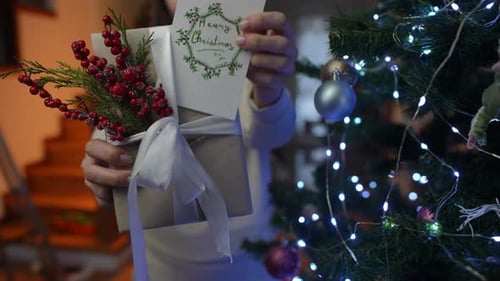 Christmas Gift Presented with Card by Christmas Tree