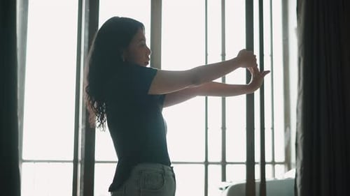 Woman Practicing Dance Moves in a Bright Room