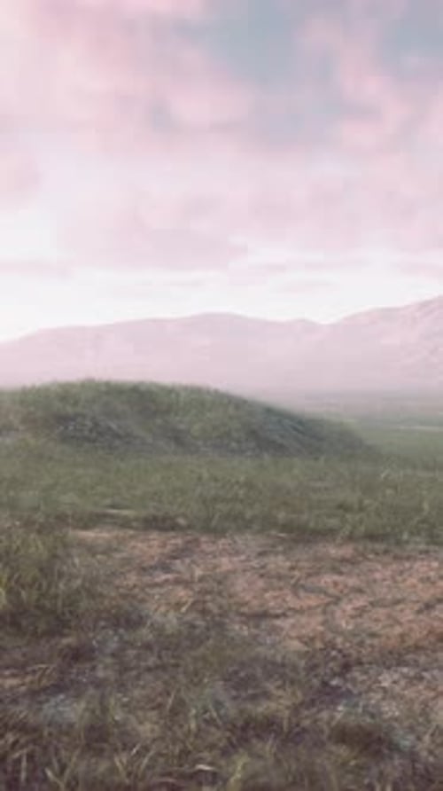 A Picturesque Landscape with Majestic Mountains and a Lush Green Field