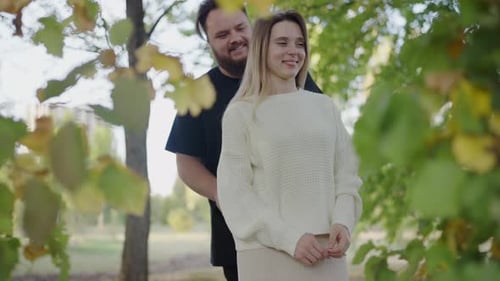 Romantic Couple Embracing in a Sunlit Park Love and Affection