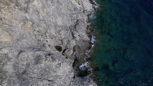 Aerial View of Rocky Coastline and Turquoise Ocean