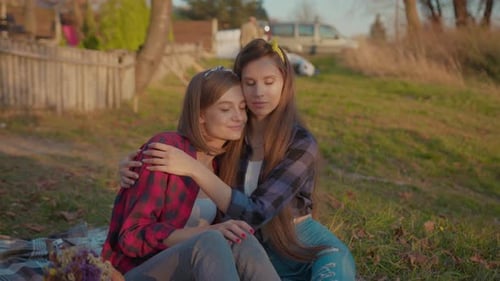 Women Enjoying a Quiet Picnic Embracing in Nature