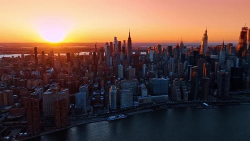 Amazing sunset in the modern metropolis. Panorama of New York, the USA at golden hour time.