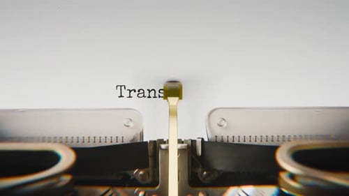 Old mechanical typewriter typing Transparency Now in a close-up view.