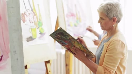 Art School Creativity and People Concept - Group of Students with Easels