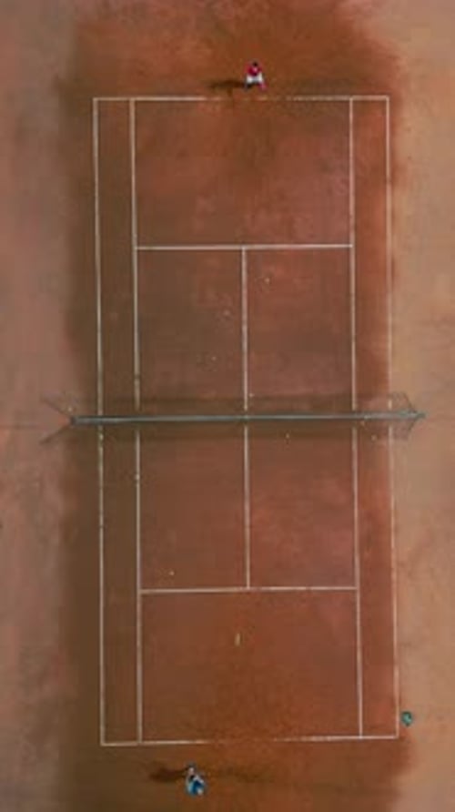Two People Playing Tennis on the Tennis Court Top Down View