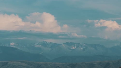Clouds Float Over Mountain Peaks