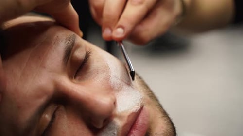 Man Getting a Straight Razor Shave in Barbershop