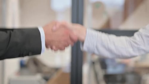 Close Up of Handshake by Business People