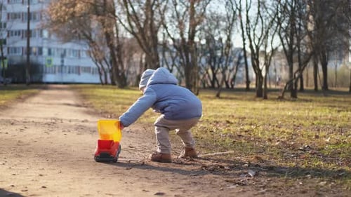Happy Baby Child Outdoor Little Toddler Boy with Toy Car Having Fun on Walk in Park Baby Son Smiling