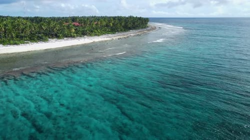 Tropical Island with Sand Beach and Transparent Ocean with Small Waves Aerial View of Maldives in
