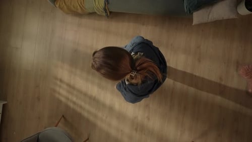 Top View of an Unhappy Woman in the Living Room Close Up The Woman is Holding Her Head and Screaming