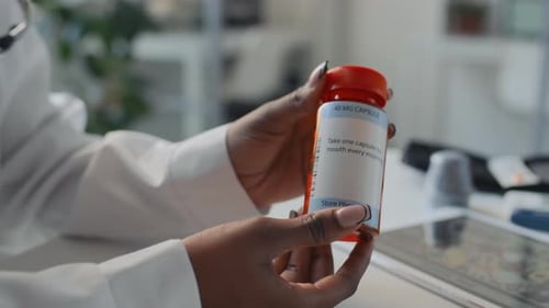 Doctor Holding Prescription Medicine Bottle Close Up