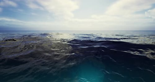 Vast Ocean Waters Reflecting Clouds Under a Bright Sky at Midday