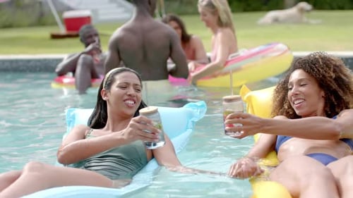 Diverse friends enjoy a pool party