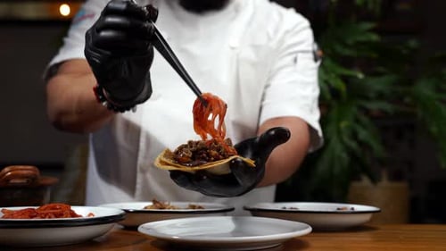 Chef Prepares Gourmet Taco with Marinated Slaw