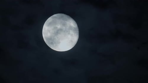 Full Moon in a Dark Cloudy Night Sky