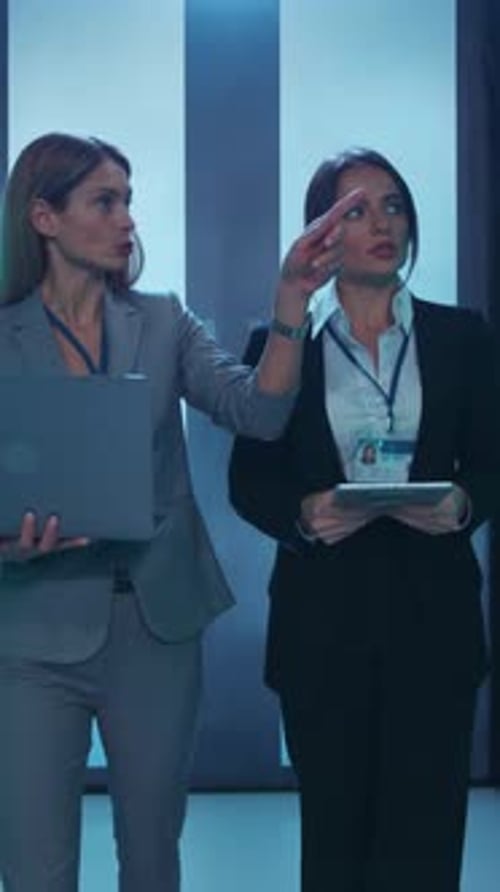 Two Accomplished Professional Women Engaged in a Dynamic Modern Office Setting Environment