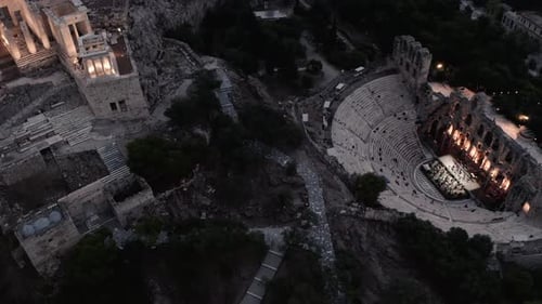 Ruins Of Ancient Theater Under Acropolis Of Athens, Greece - aerial drone shot
