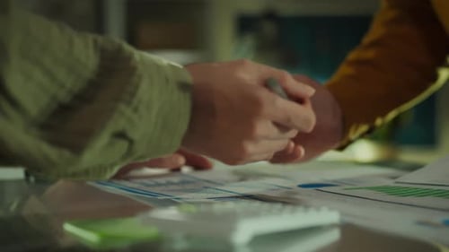 Colleagues in office clothes actively discussing digital data in an innovative creative office