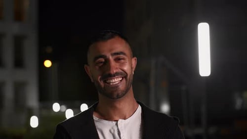 Smiling Man in Urban Night Setting