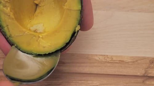 Avocado Fruit Being Scooped Out