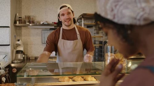 Bakery Worker Giving Recommendations about Pastry to Customer