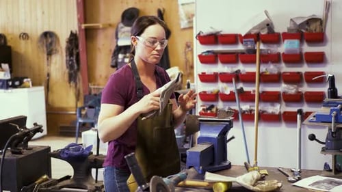 Craftswoman Preparing Protective Gear in Workshop