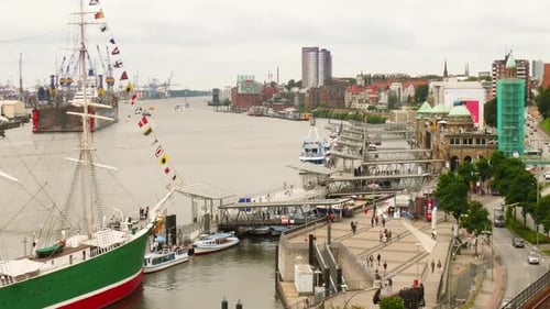Time lapse shot of the port of Hamburg with the famous Landungsbrucken in the foreground and many pa